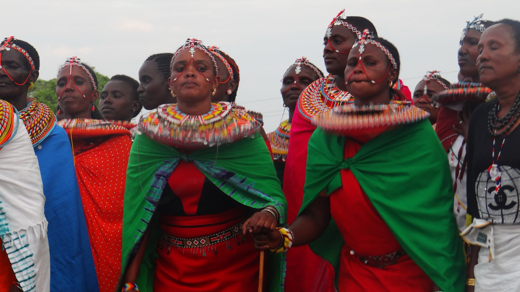 Samburu women in traditional dress with layers of beaded necklaces and headpieces.